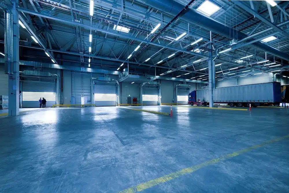 Large empty warehouse with loading docks and industrial ceiling for yard management operations