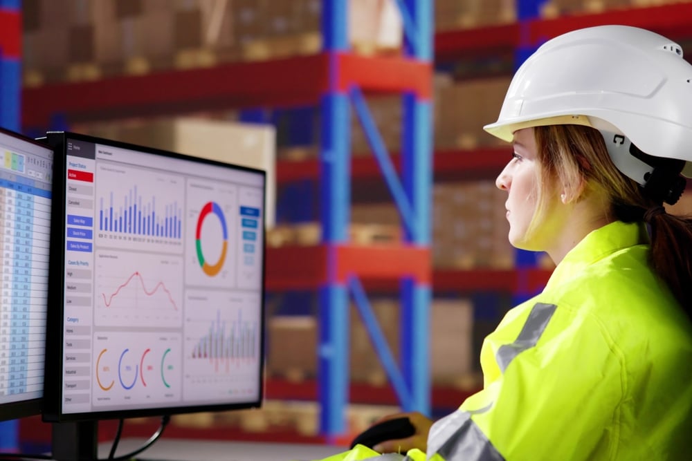 female supervisor viewing warehouse kpi dashboard