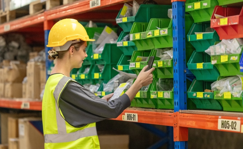 female worker finding items with warehouse rack labels